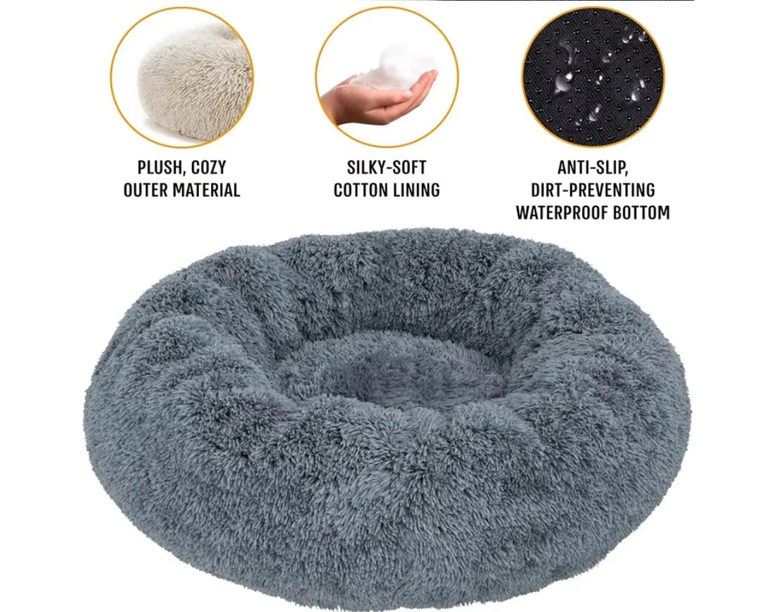 Soft plush round pet bed by Ditzy Petunia with a raised rim, washable base, available in multiple sizes and colors for dogs and cats.